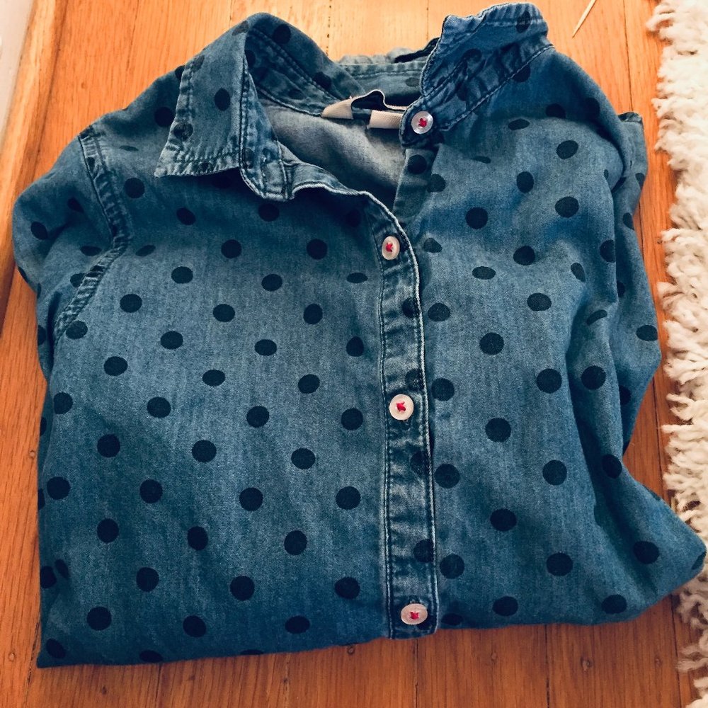 COPY - A navy blue poka-dot collared button down …